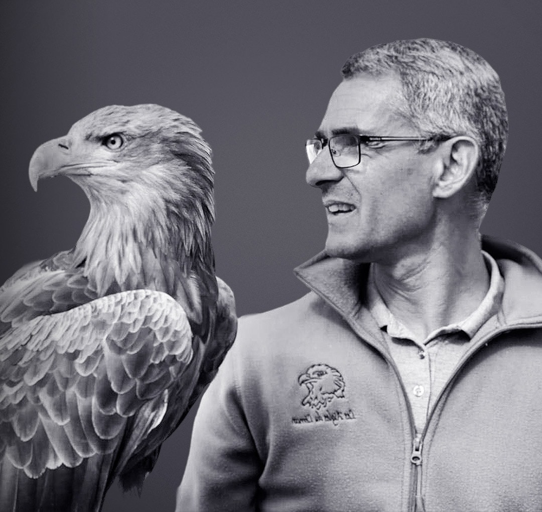 Black and white portrait of Jacques-Olivier Travers alongside an eagle.